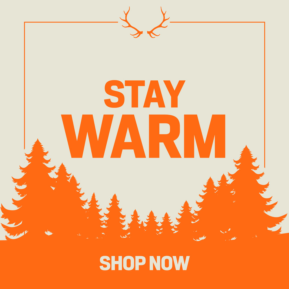 Beige ad graphic with orange "STAY WARM SHOP NOW" text, antlers, border, and pine trees.