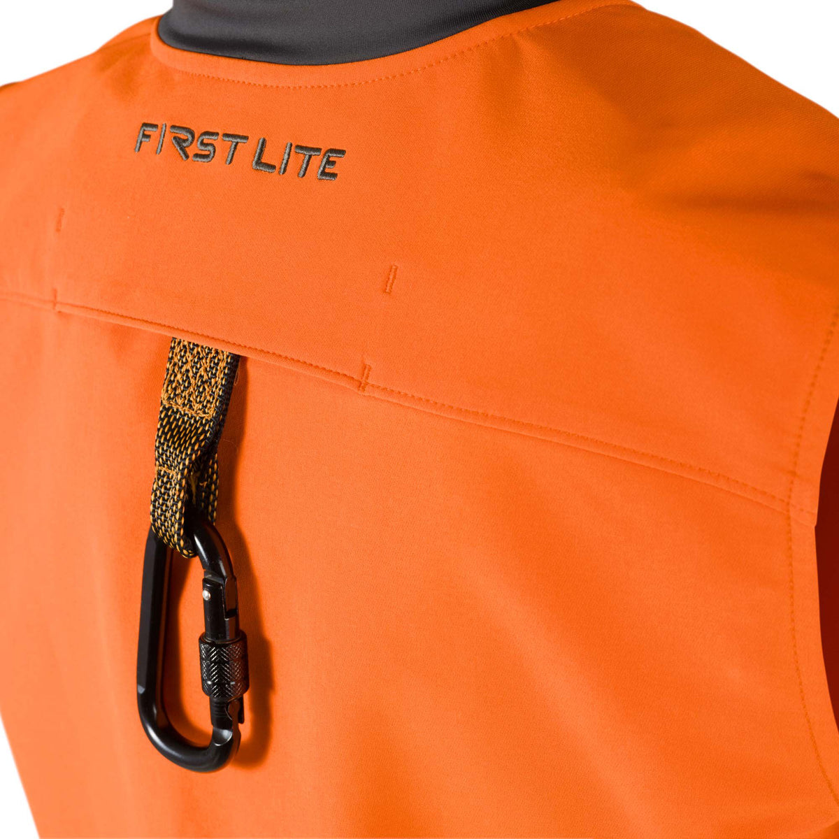 Orange vest with a black "FIRST LITE" logo on the upper back and a black carabiner attached to a black and yellow strap.