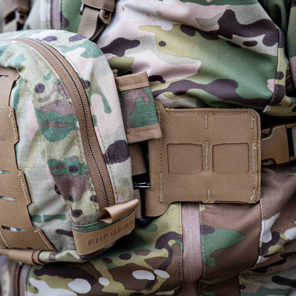 Multicam camouflage tactical pouch with tan zipper, FHF GEAR label, and an adjacent tan laser-cut MOLLE panel and buckle on a camouflage vest.