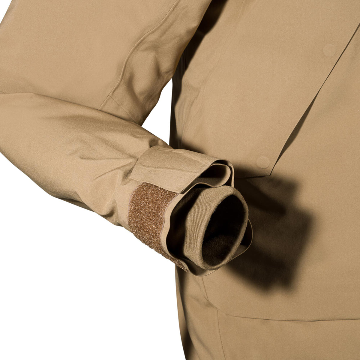 Tan jacket sleeve with an adjustable hook-and-loop cuff and an elastic inner cuff.
