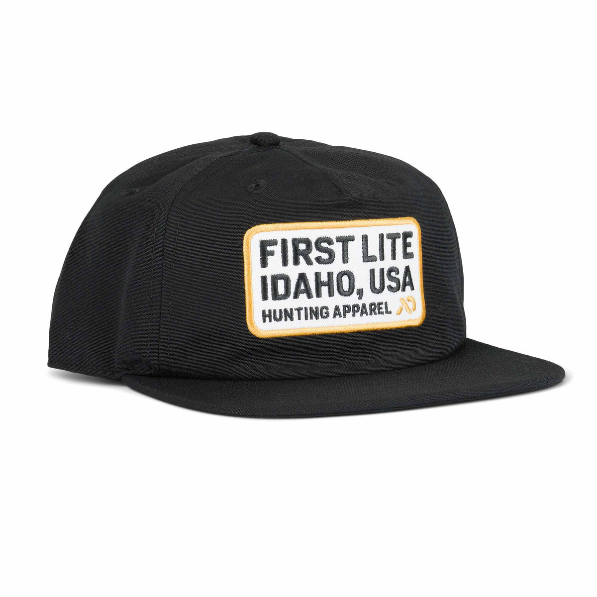 Black cap with a white rectangular patch featuring "FIRST LITE IDAHO, USA HUNTING APPAREL" in black text and a yellow border.