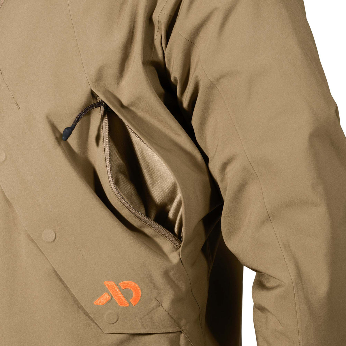 Tan jacket featuring an open zippered chest pocket and an orange logo on a lower flap pocket with snap closures.