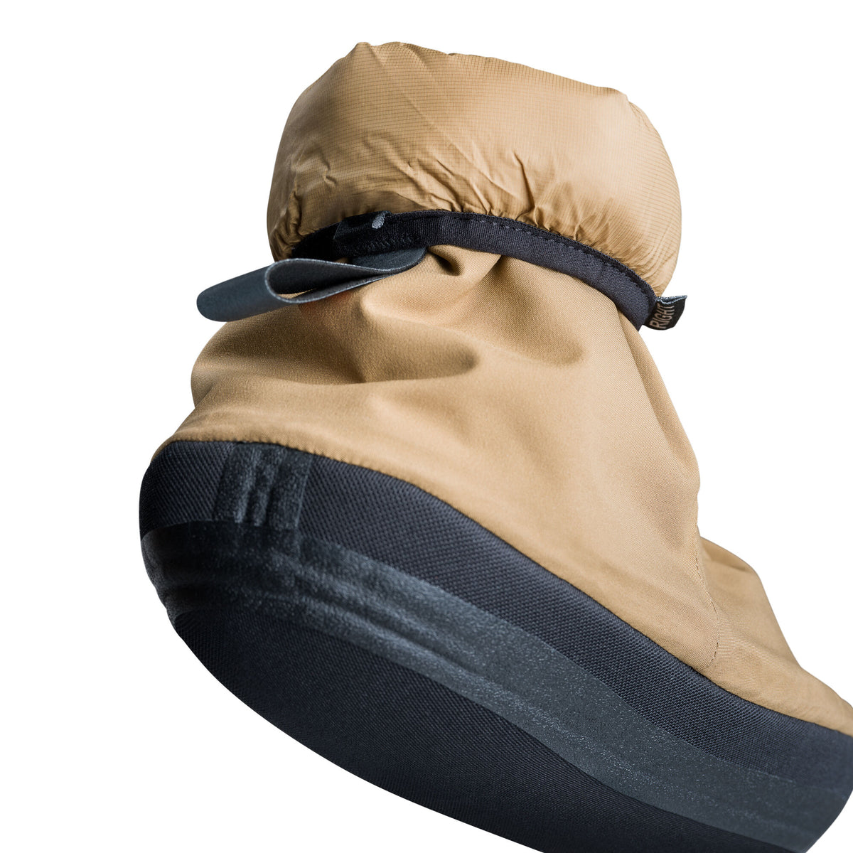 A tan camp bootie with a black sole and an adjustable black ankle strap.