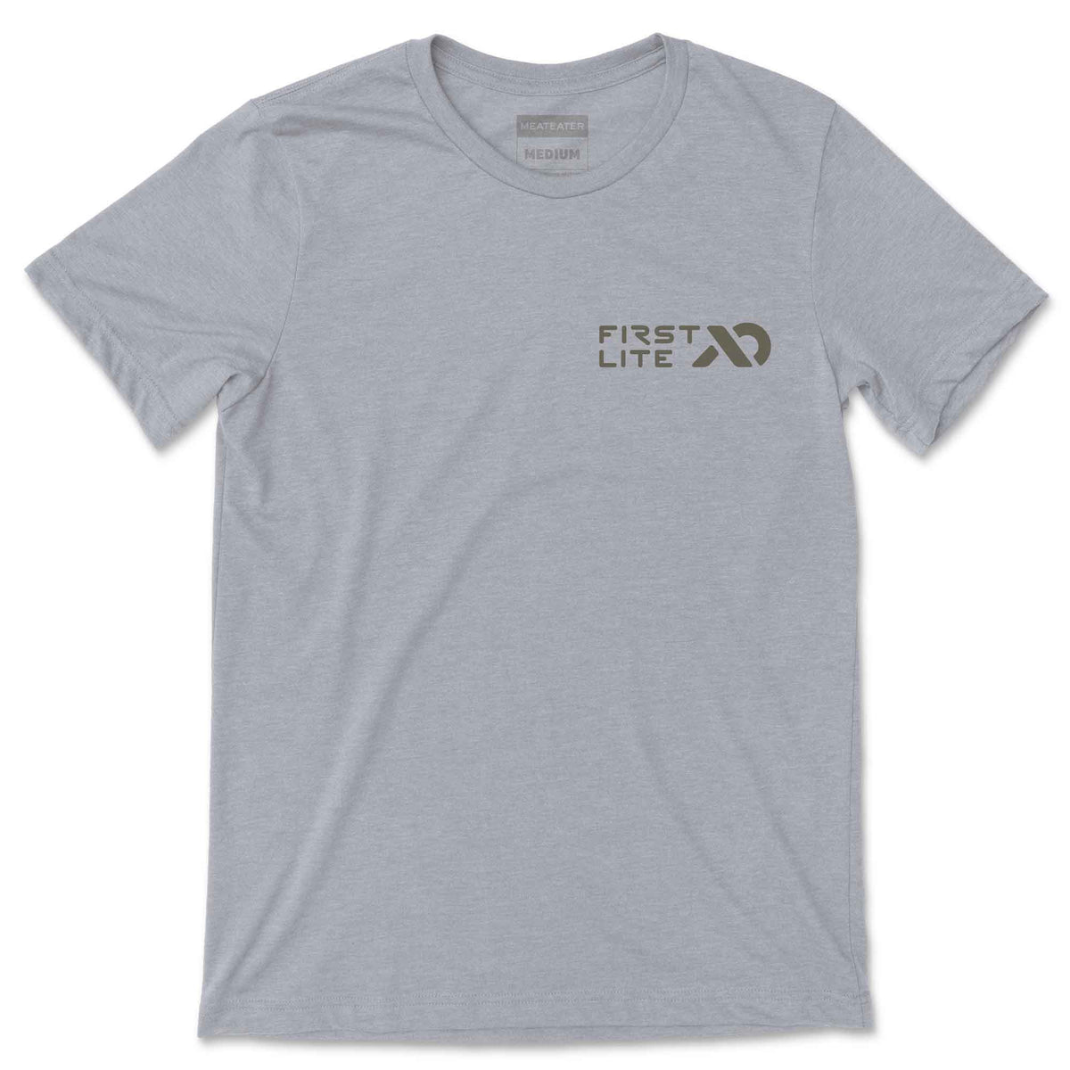 Light grey short-sleeve t-shirt with a dark grey "FIRST LITE" logo on the chest and a "MEATEATER MEDIUM" tag at the collar.