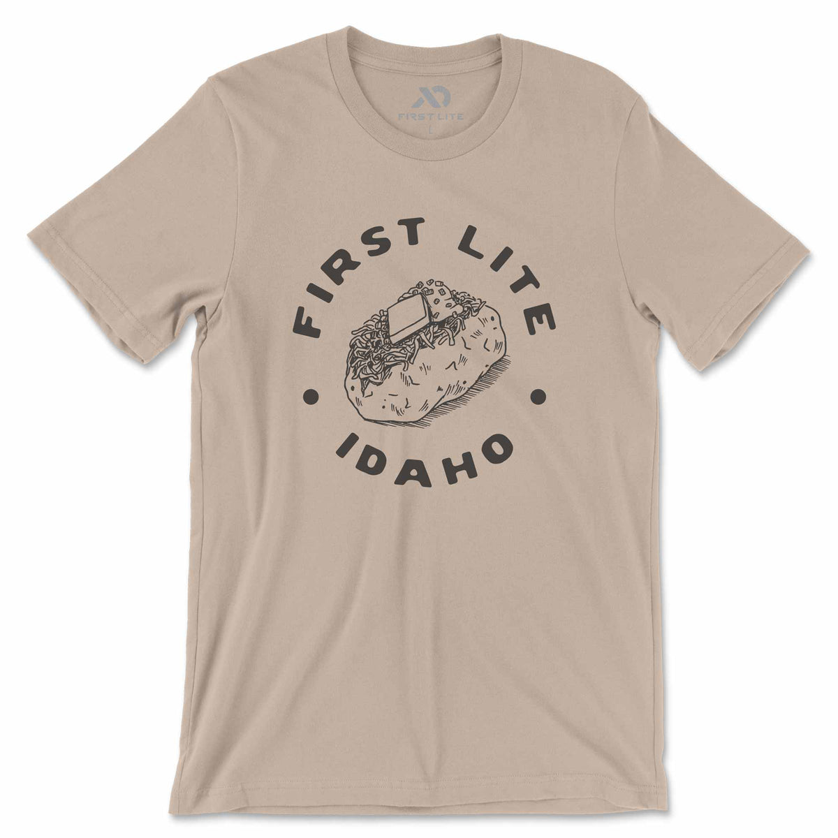 Beige t-shirt with 'First Lite Idaho' baked potato graphic on a white background
