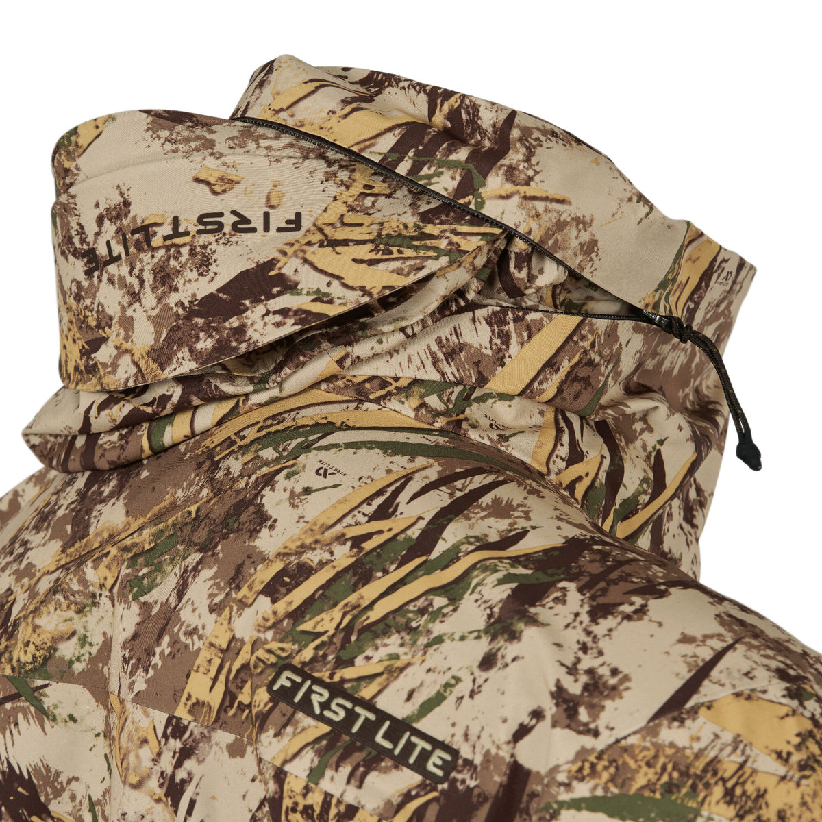 First Lite hooded jacket in brown, tan, and green camouflage, featuring a black zipper and drawstring.