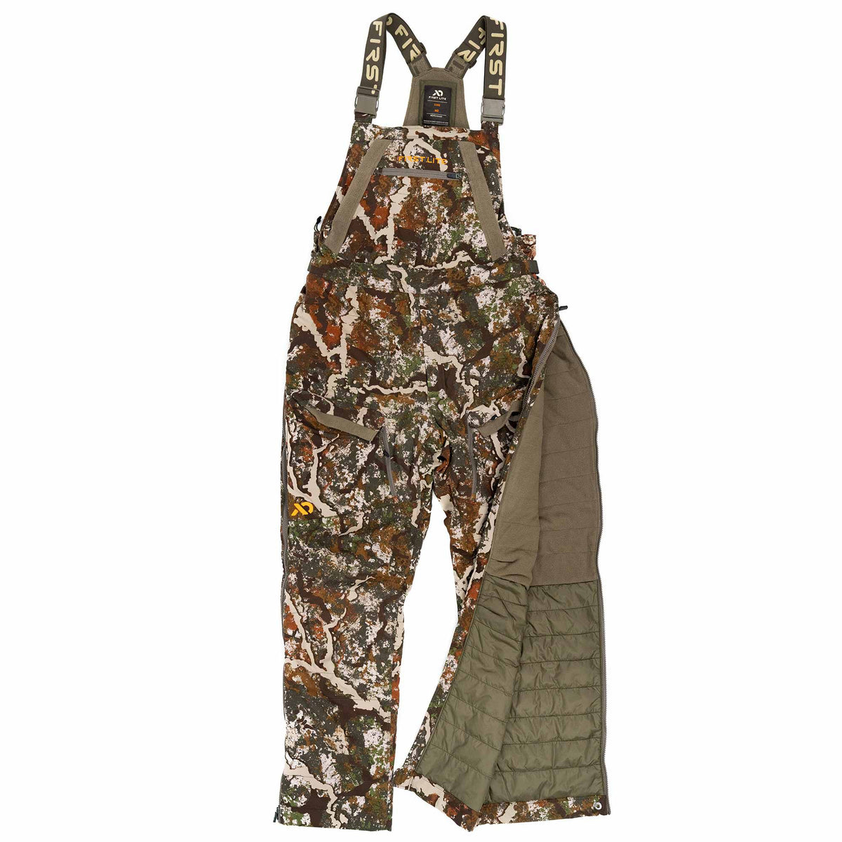 First Lite Fusion camouflage hunting bibs with logo suspender straps and a full side leg zipper open to reveal quilted olive insulation.