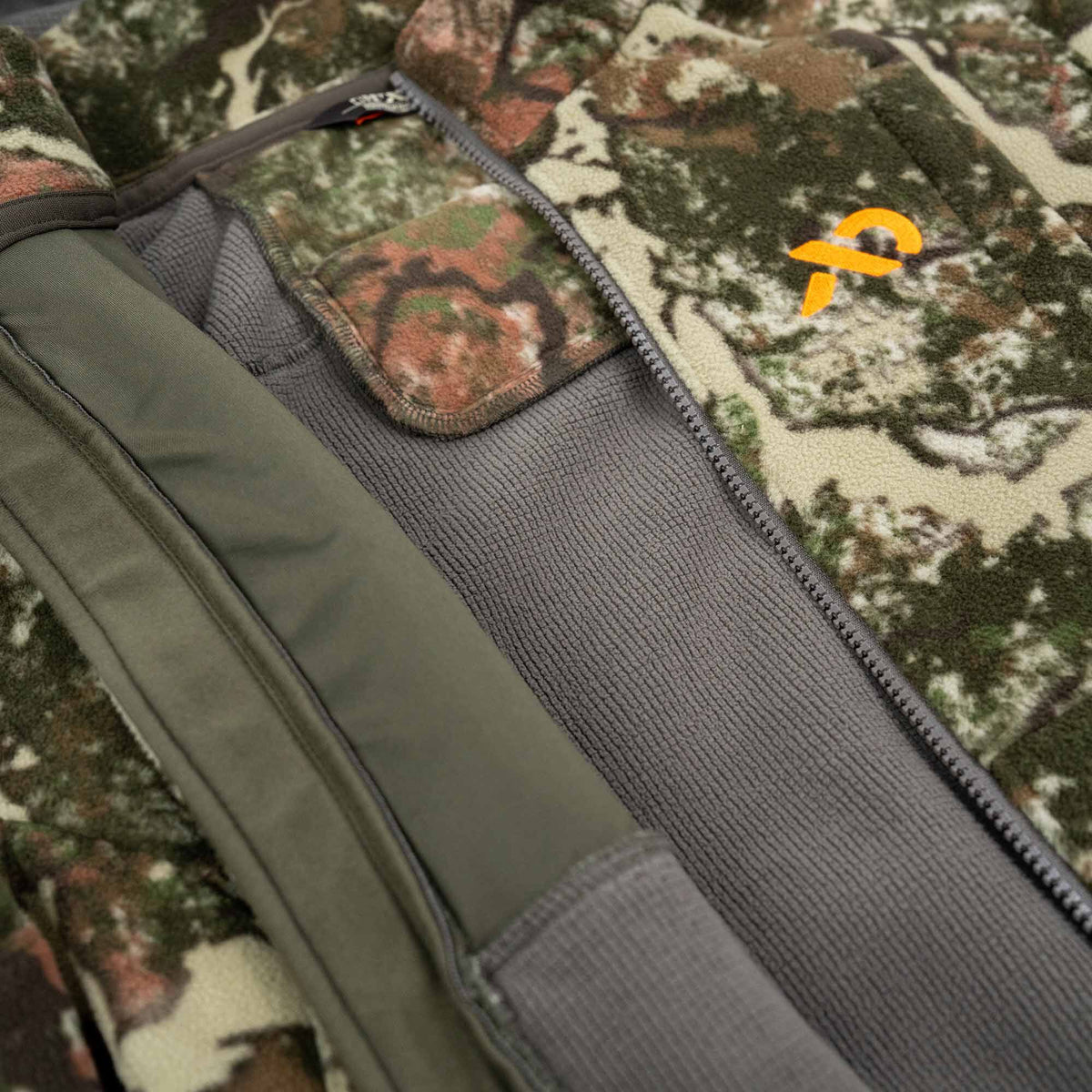 Camouflage fleece jacket with a grey zipper, textured grey lining, and an orange logo.