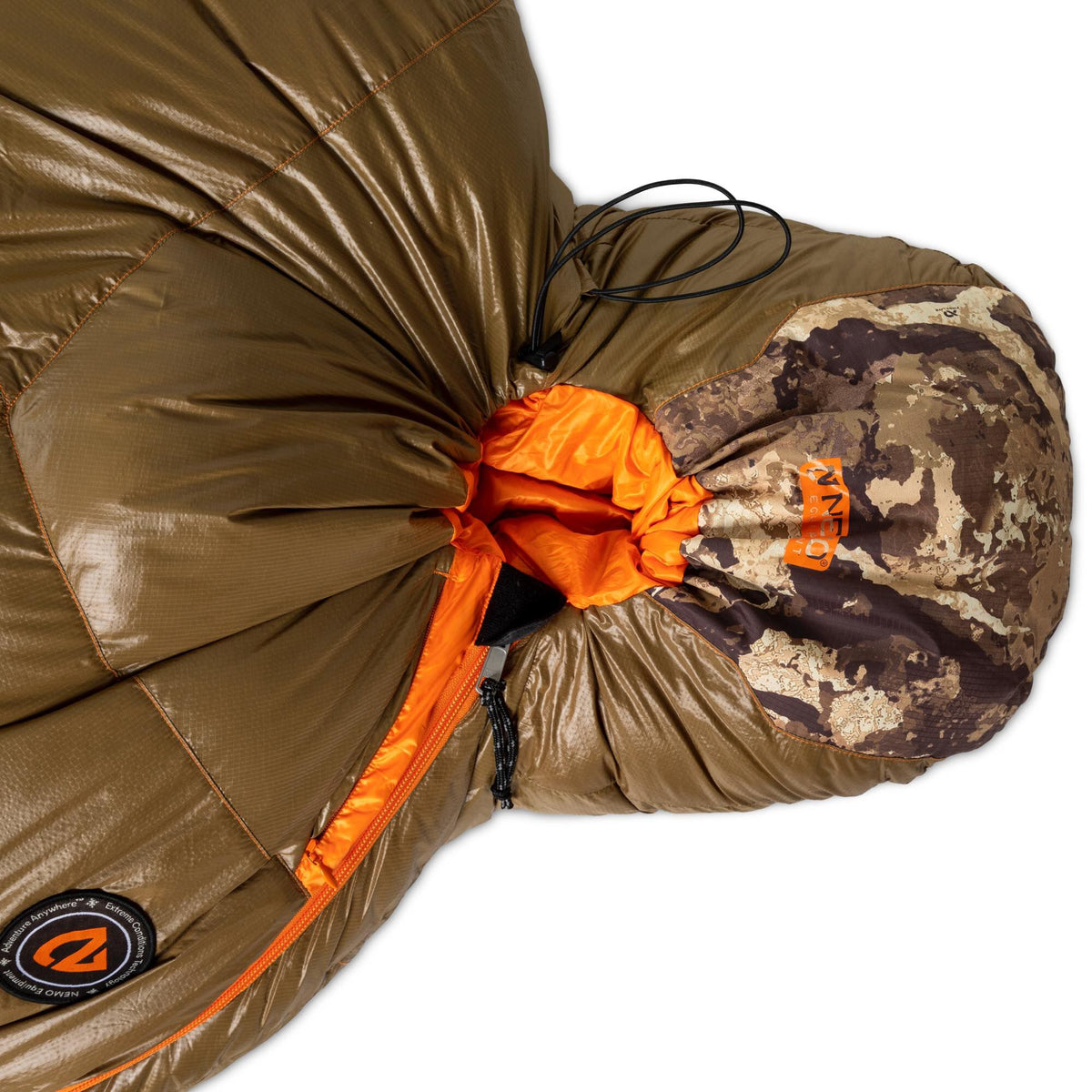 Olive green sleeping bag with a bright orange interior and zipper, a camouflage drawstring hood, and a visible Nemo logo.