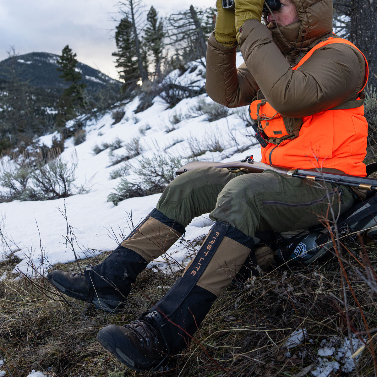 Man wearing boot gaiters glassing on a hillside in the snow