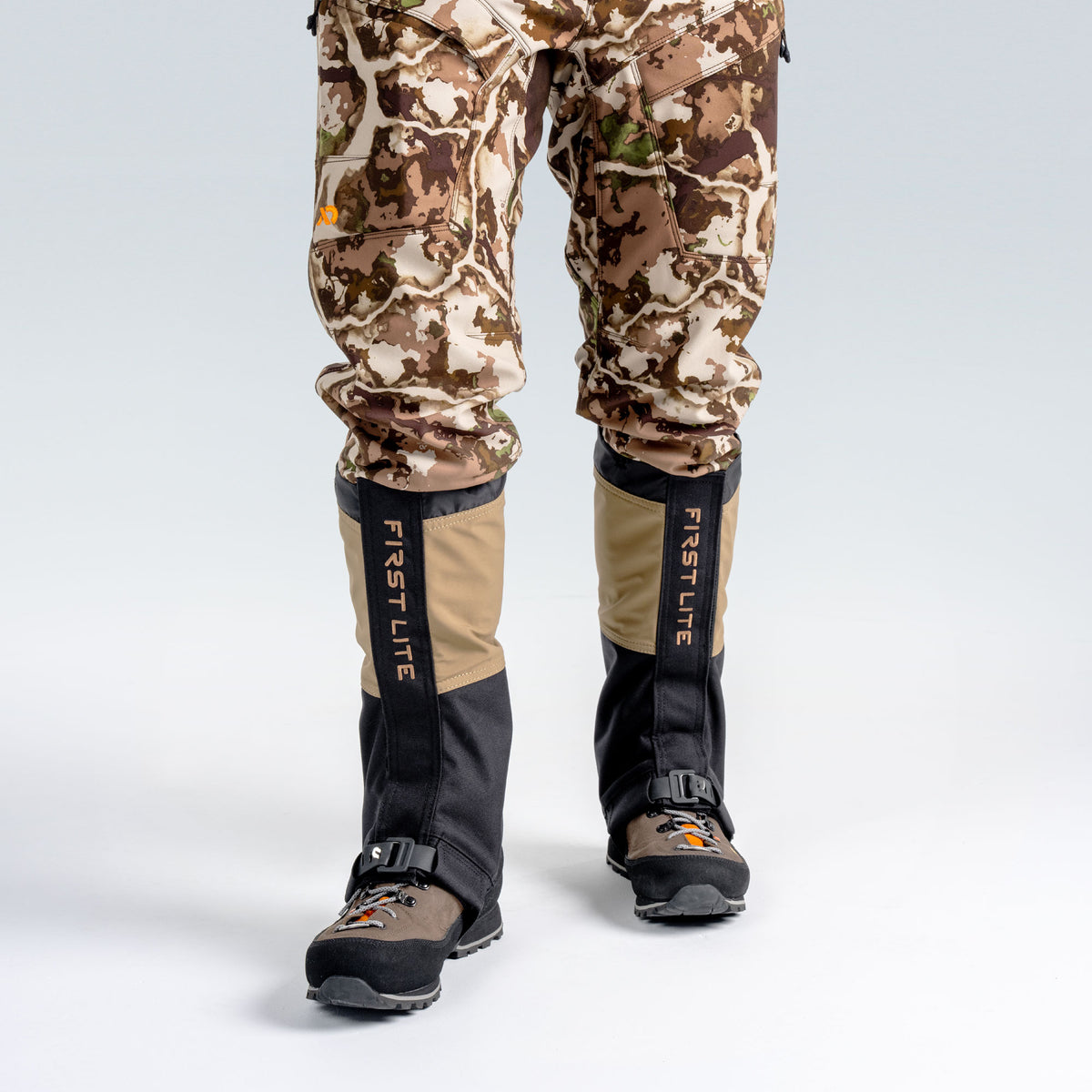 Model wearing First Lite boot gaiters, facing forward