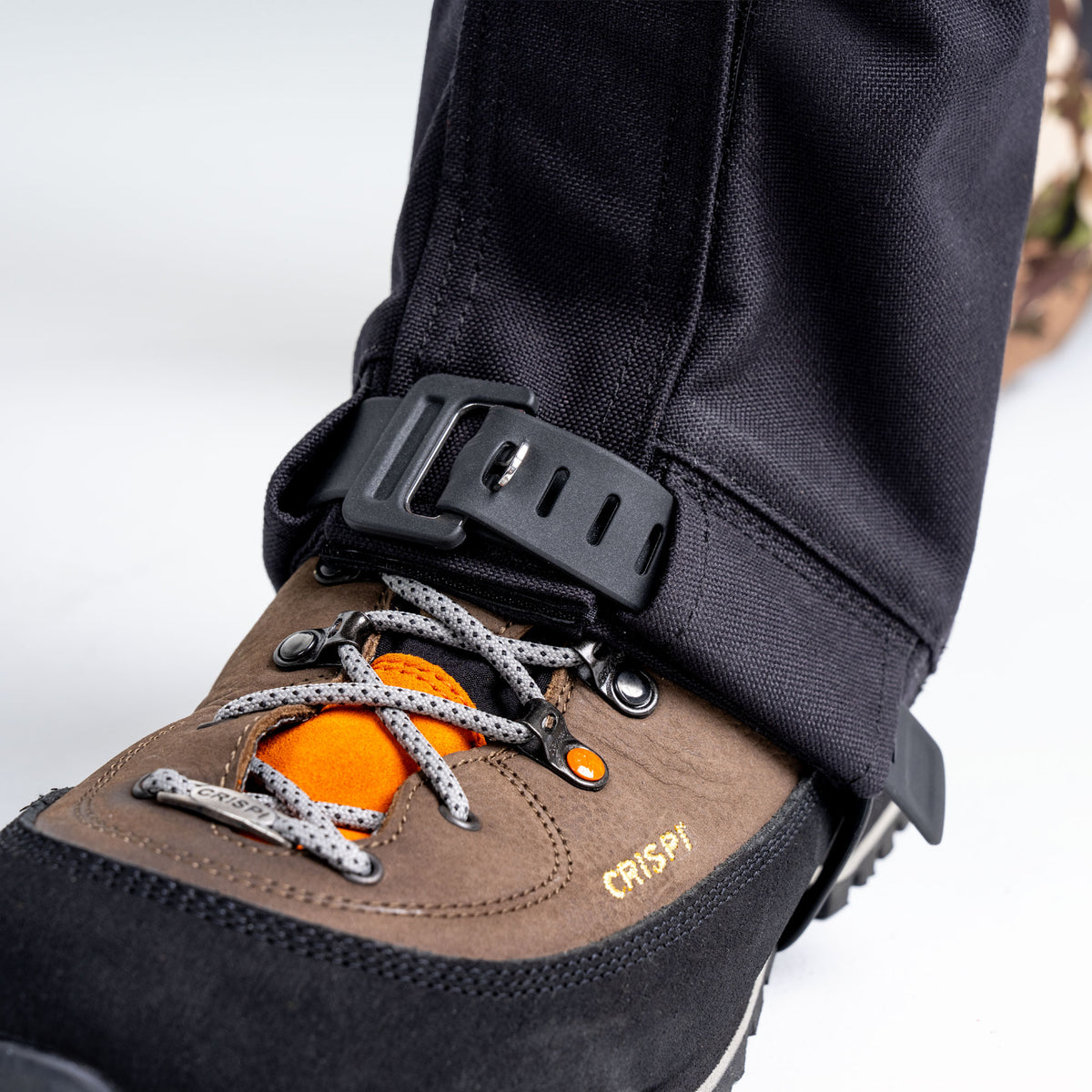 Close up of hunting boot and boot gaiter with adjustable strap