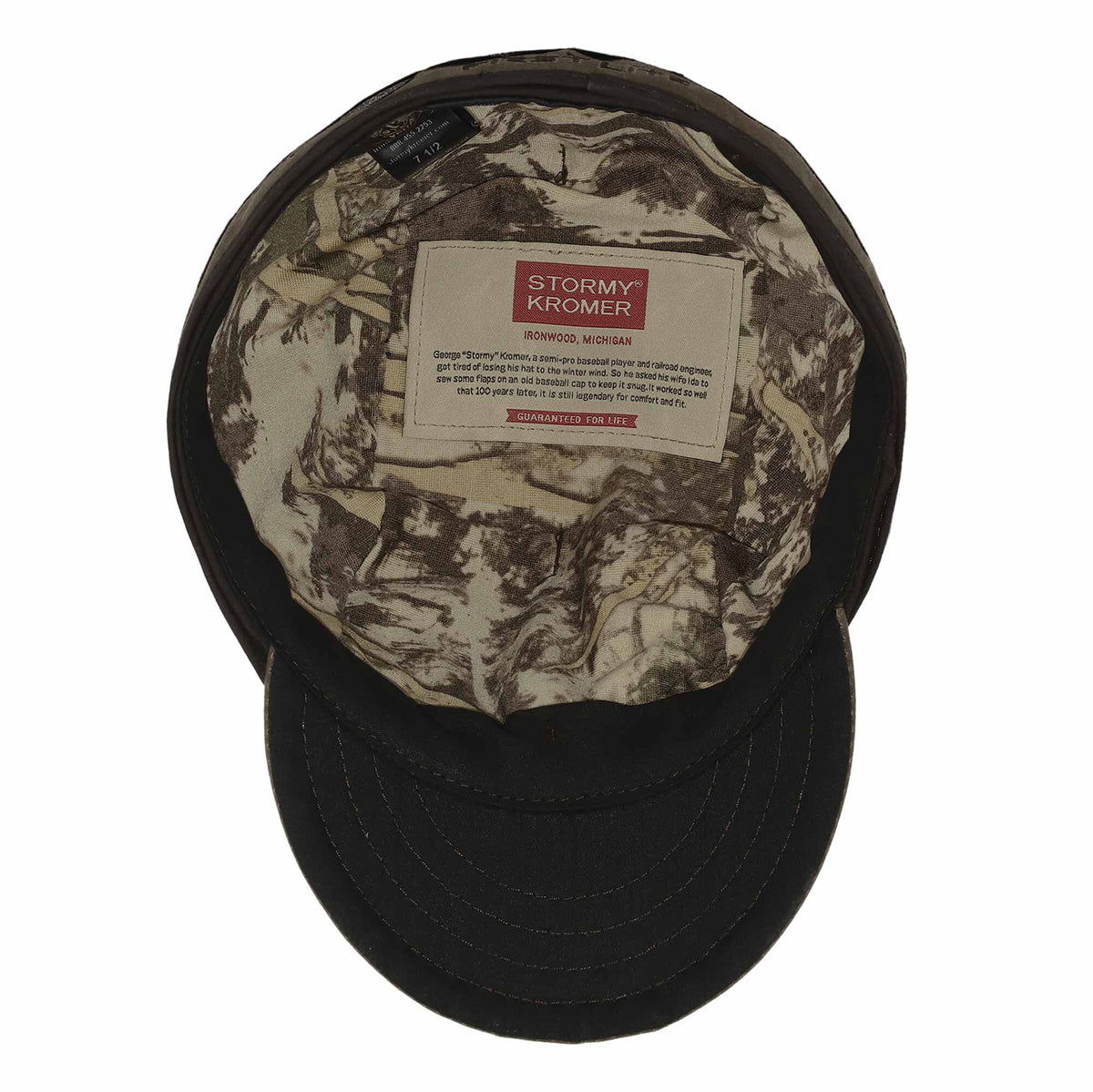 Dark Stormy Kromer cap with camouflage lining and an inner label mentioning ear flaps.