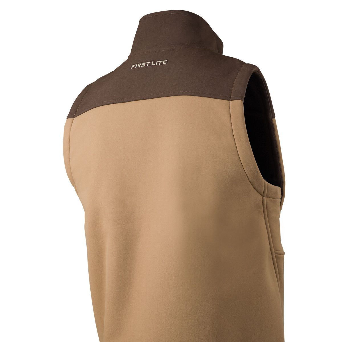 Tan and dark brown sleeveless vest featuring a high collar and "FIRST LITE" logo embroidered on the upper back.