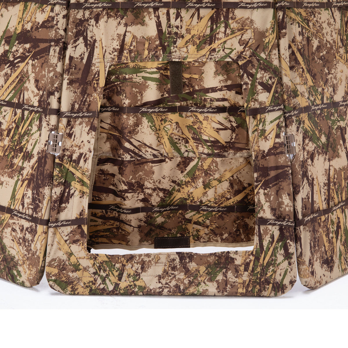 Marsh camouflage hunting blind with a central window and "Tanglefree" branded straps.