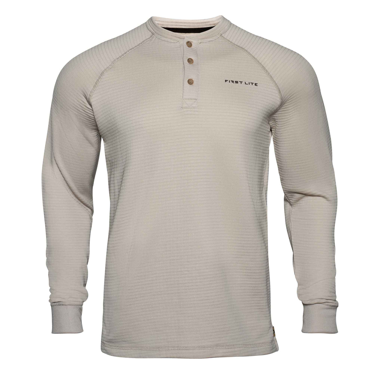 Light tan First Lite long-sleeve Henley shirt with a horizontal ribbed texture, raglan sleeves, three brown buttons, and ribbed cuffs.