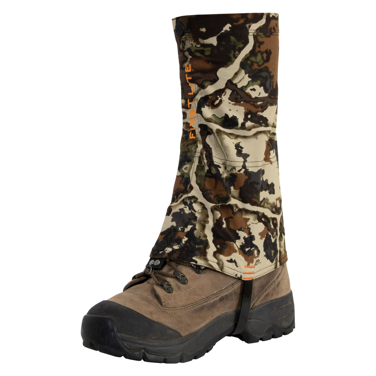First Lite Fusion camouflage gaiter with orange branding, shown worn over a brown hiking boot.