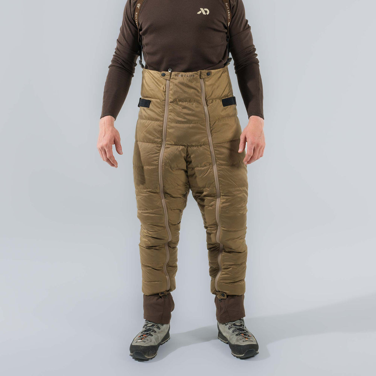 First Lite olive green insulated bibs with full-length leg zippers and suspenders.