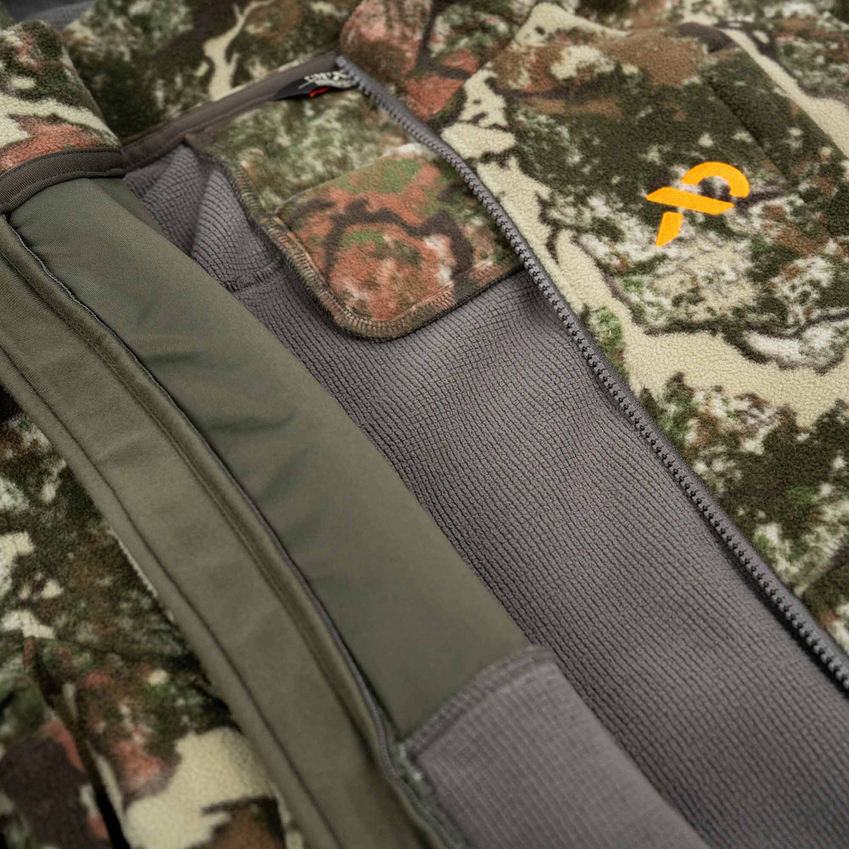 Camouflage fleece jacket with grey thermal lining, a visible zipper, and an orange logo.