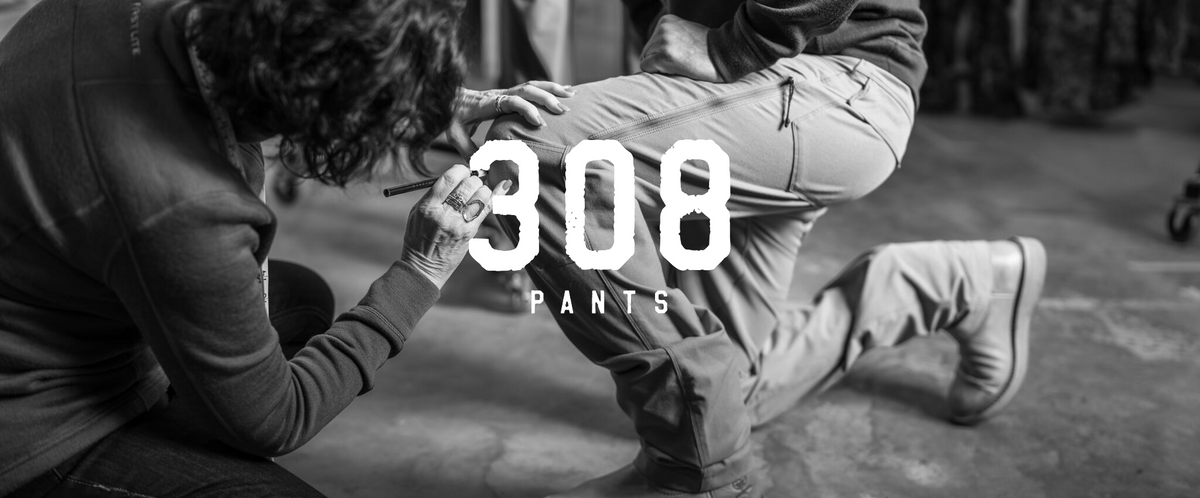 Light-colored 308 pants with cargo and zippered thigh pockets, on a kneeling person.