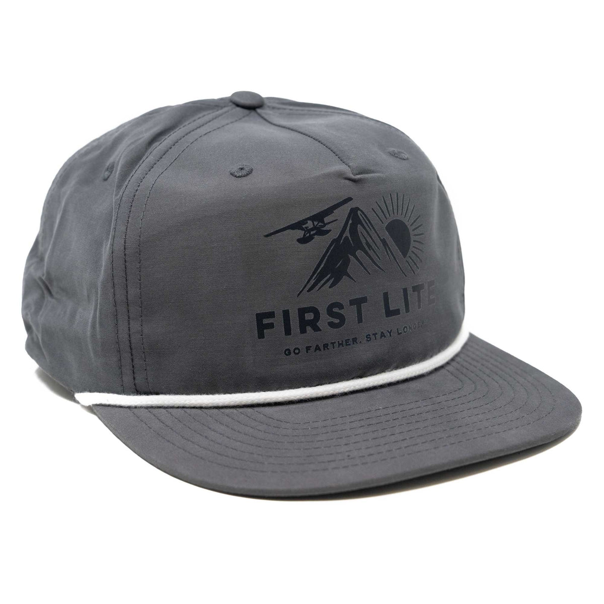 Dark grey cap with a white rope trim on the brim and a black "FIRST LITE" logo featuring mountains, sun, and a seaplane.
