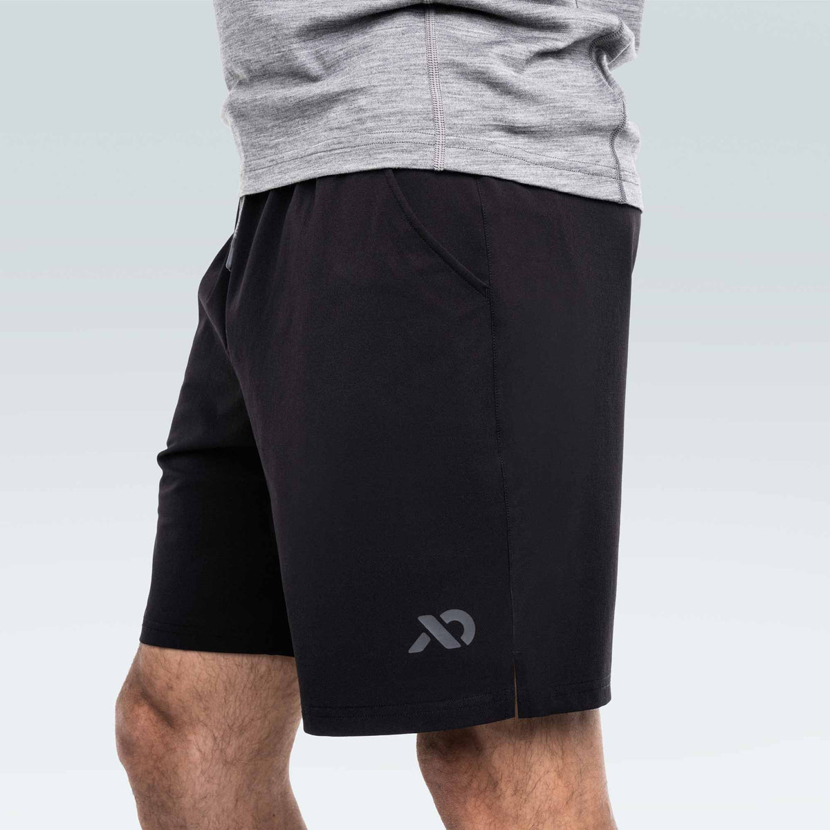 Black athletic shorts with a First Lite logo on a plain background