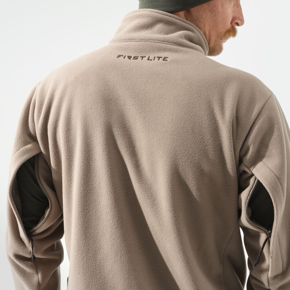 Tan fleece jacket with FIRST LITE logo on back and zipped arm vents.