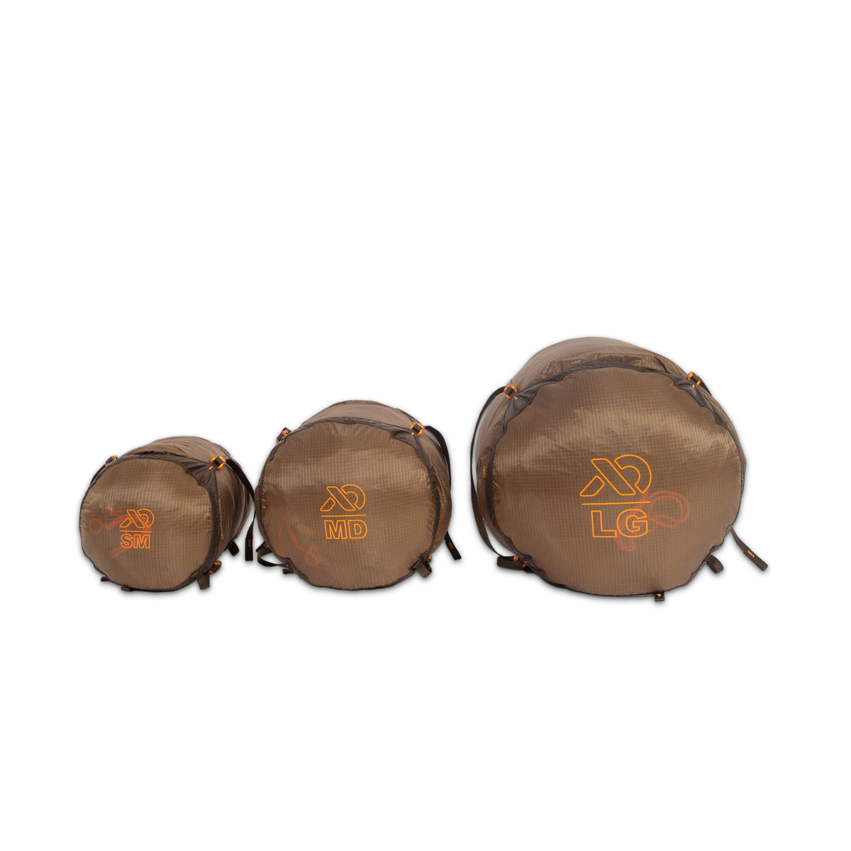 Three brown ripstop compression sacks in small, medium, and large sizes, each with orange text and compression straps.