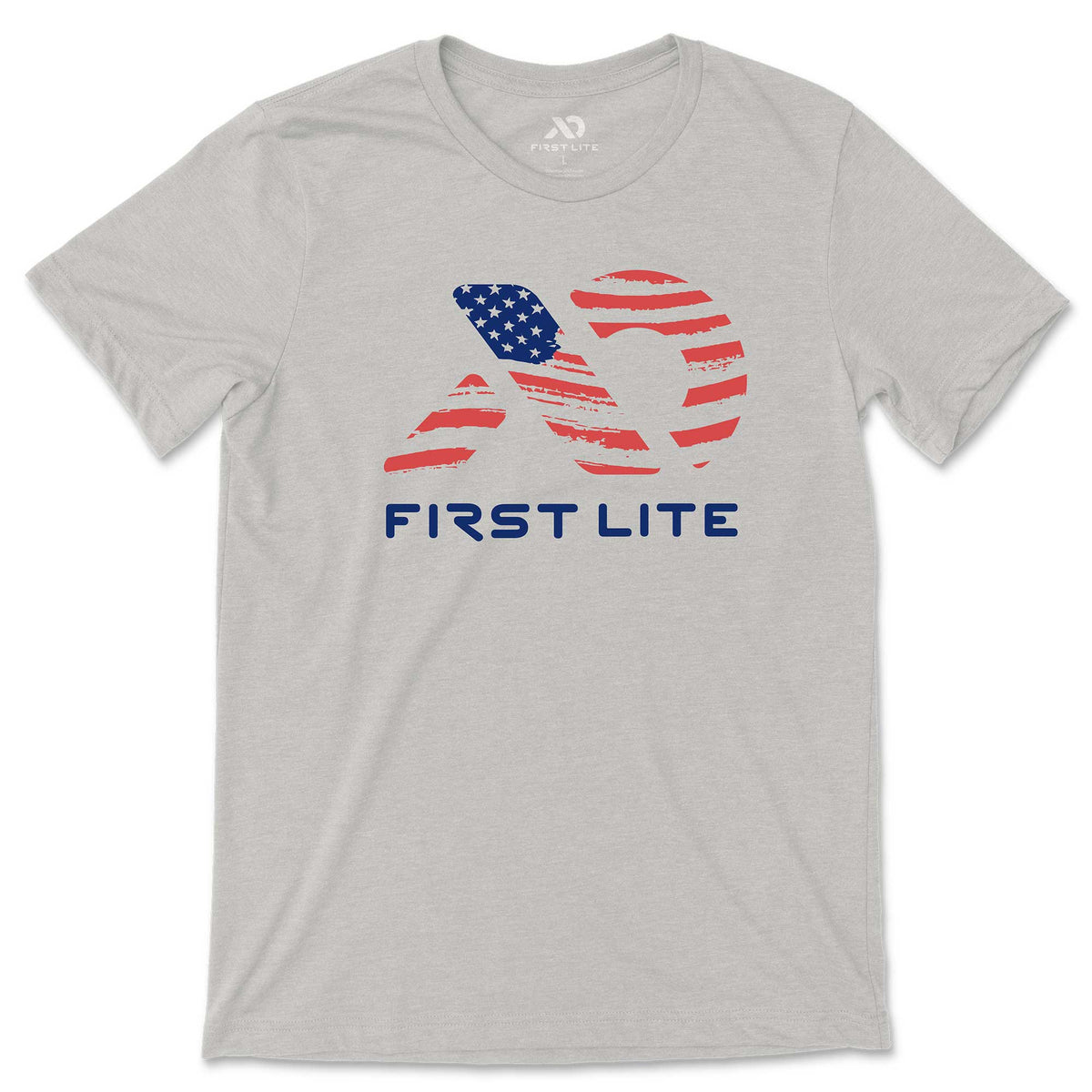 Heather grey t-shirt with a distressed American flag-patterned First Lite logo and "FIRST LITE" text in blue on the chest.