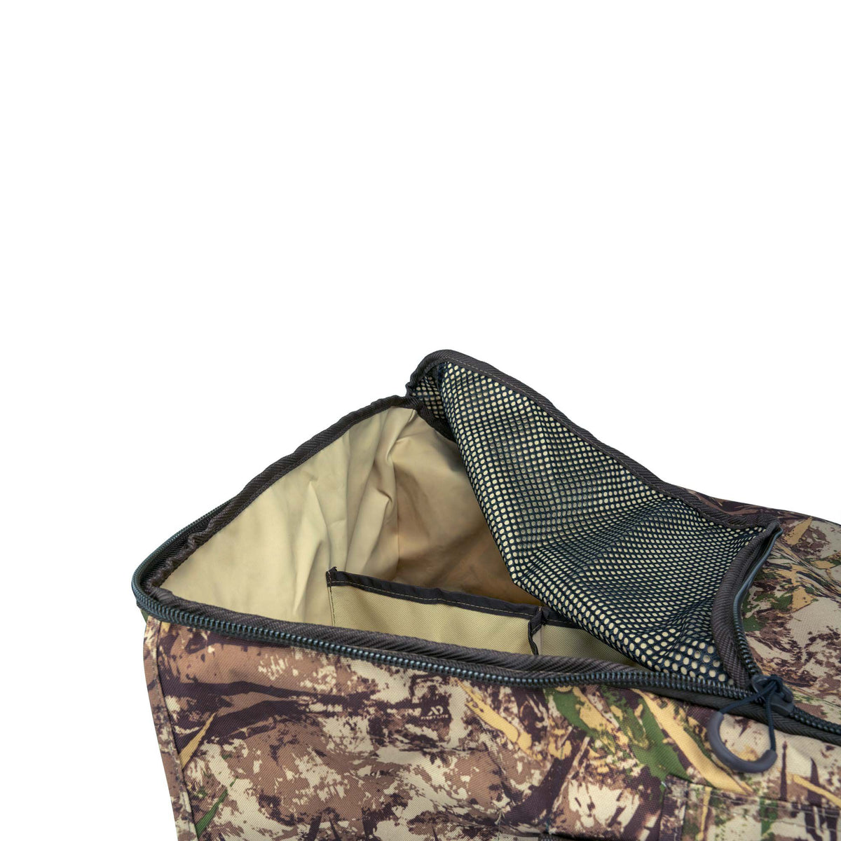 First Lite camouflage gear bag, partially unzipped, showing light tan interior lining and an open black mesh pocket.