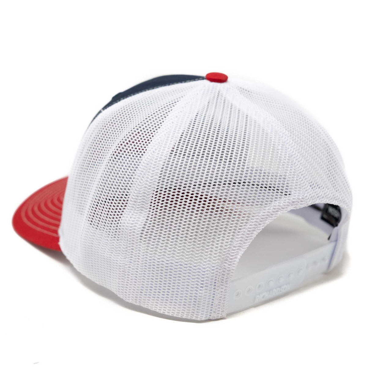 Rear view of a navy blue and red trucker hat with a white mesh back and adjustable snap closure.
