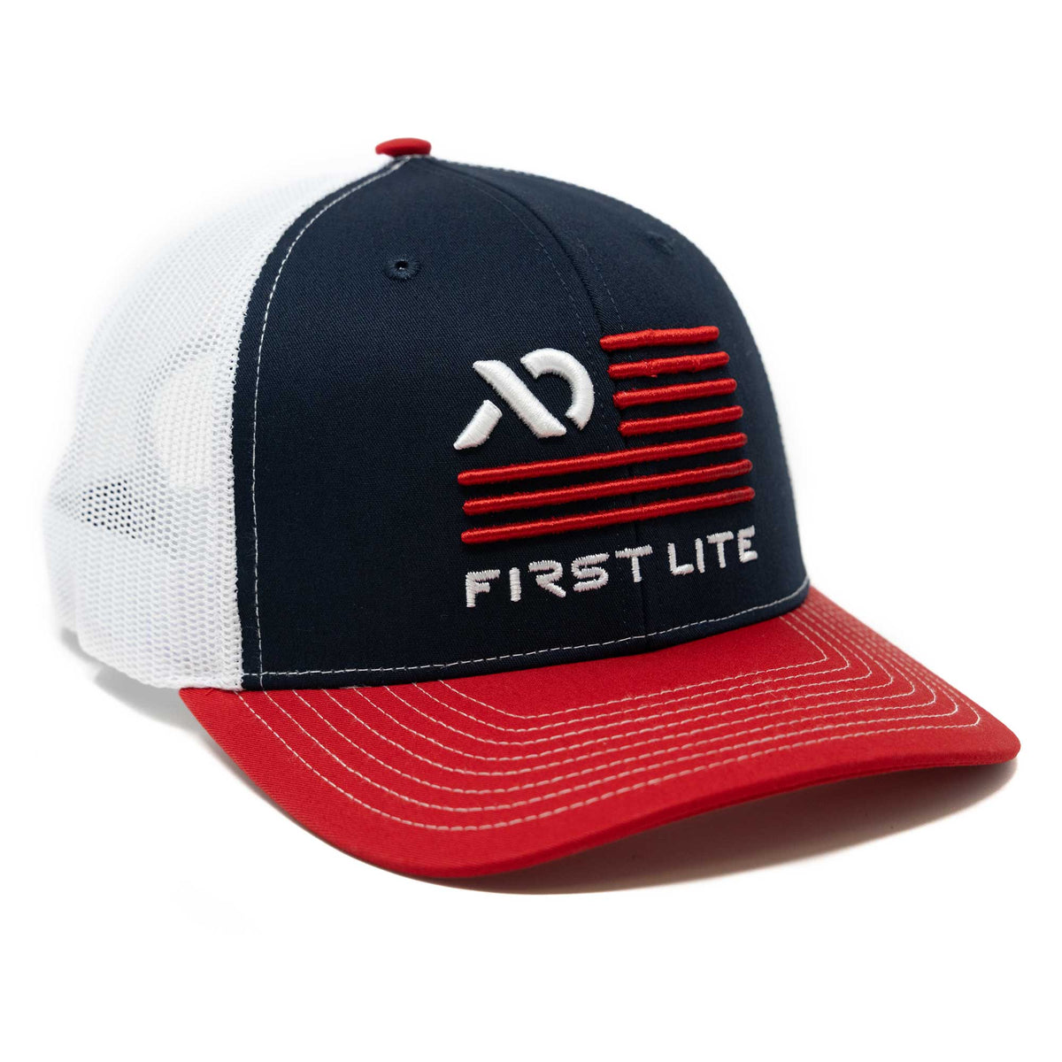 Navy blue and white mesh trucker hat with red brim, embroidered with white First Lite logo, text, and red stripes on the front.
