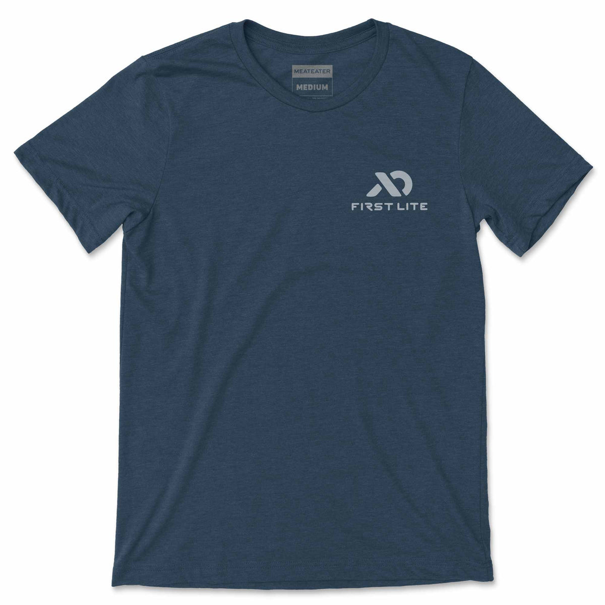 A heathered navy blue t-shirt with "MEATEATER MEDIUM" printed inside the collar and a light gray "FIRST LITE" logo on the left chest.