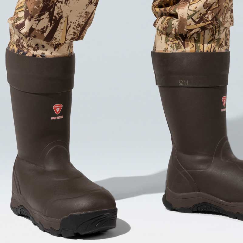 Brown PrimaLoft 1000 Gram insulated boots with red logo and black rubber soles.