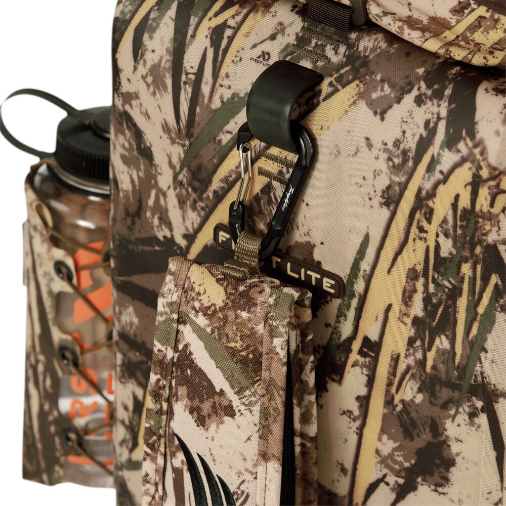 FirstLite camouflage backpack showing a water bottle in a side pocket and a matching pouch attached with a black carabiner.