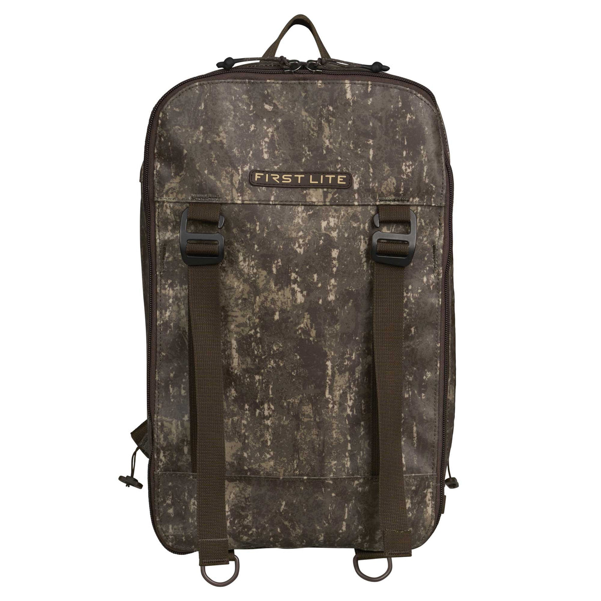 First Lite camouflage pack featuring a top handle, two front webbing straps with buckles, and two bottom D-rings.