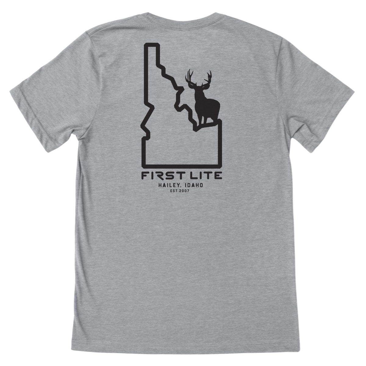 Light gray t-shirt with a black graphic on the back showing an Idaho state outline with a deer silhouette inside and text "FIRST LITE HAILEY, IDAHO EST.2007"