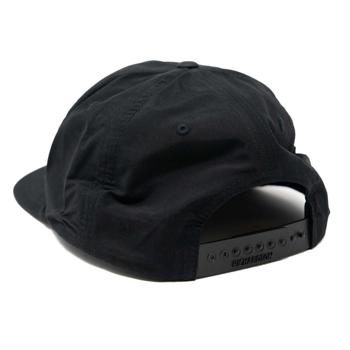 Black baseball cap, rear view, with a Richardson branded snapback closure.