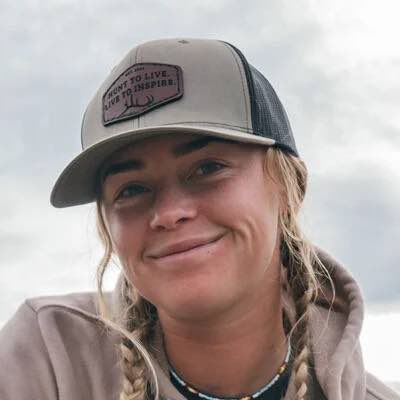 Tan & black trucker hat with leather patch featuring "HUNT TO LIVE. LIVE TO INSPIRE."