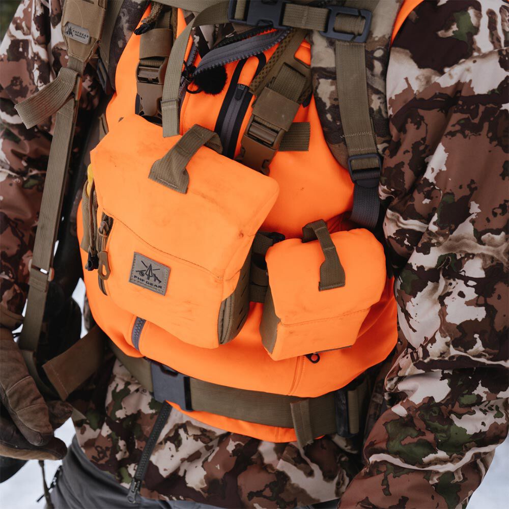 Bright orange hunting chest rig worn over camouflage, featuring two attached pouches with olive green straps and the FHF GEAR logo.