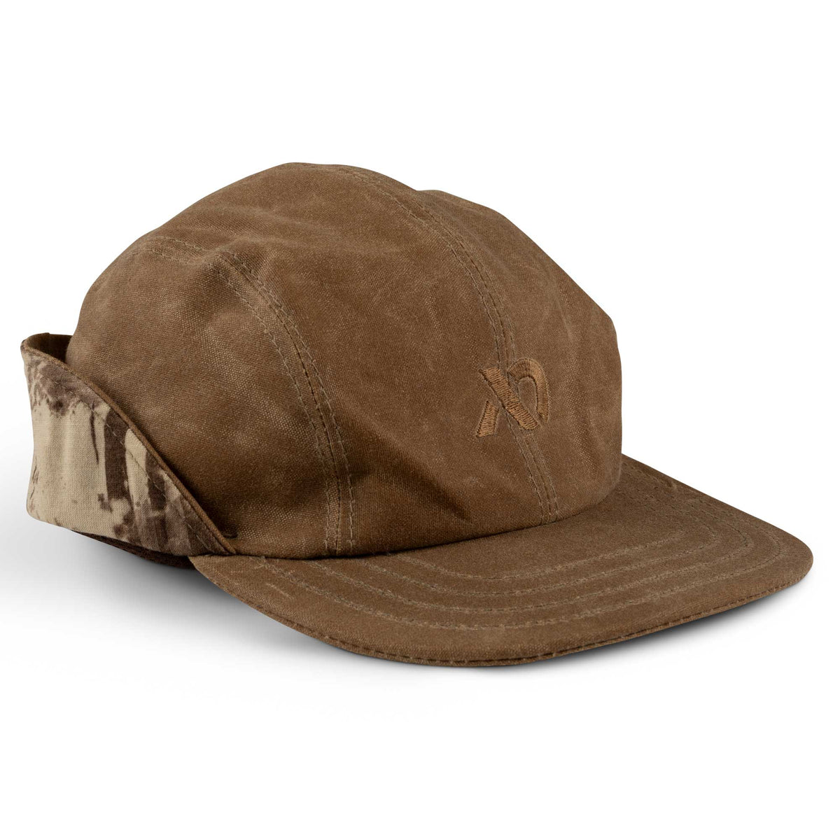 Brown waxed canvas cap with folded-up camouflage ear flaps and an embroidered "XO" logo on the front.
