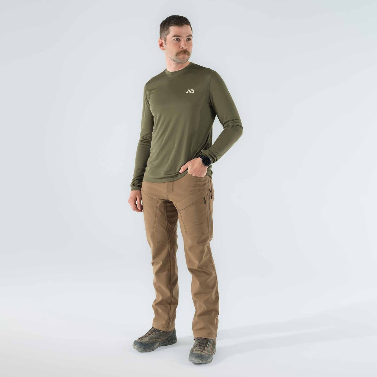 Men's olive green long-sleeve shirt with white logo and tan tactical pants with knee reinforcements and zippered pockets.