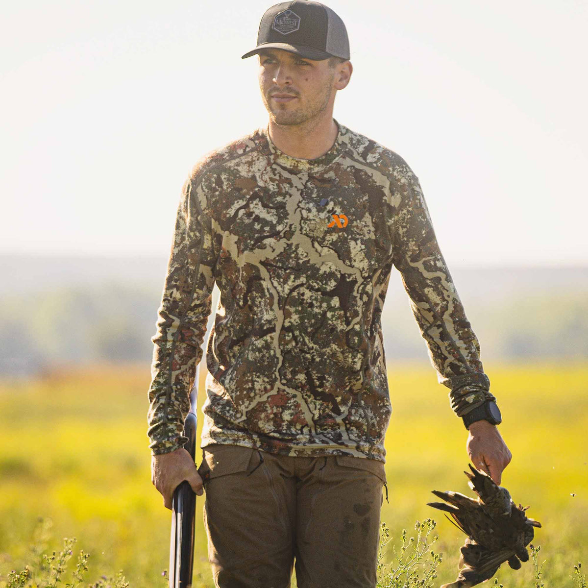 Men's camouflage long-sleeve hunting shirt with an orange chest logo.