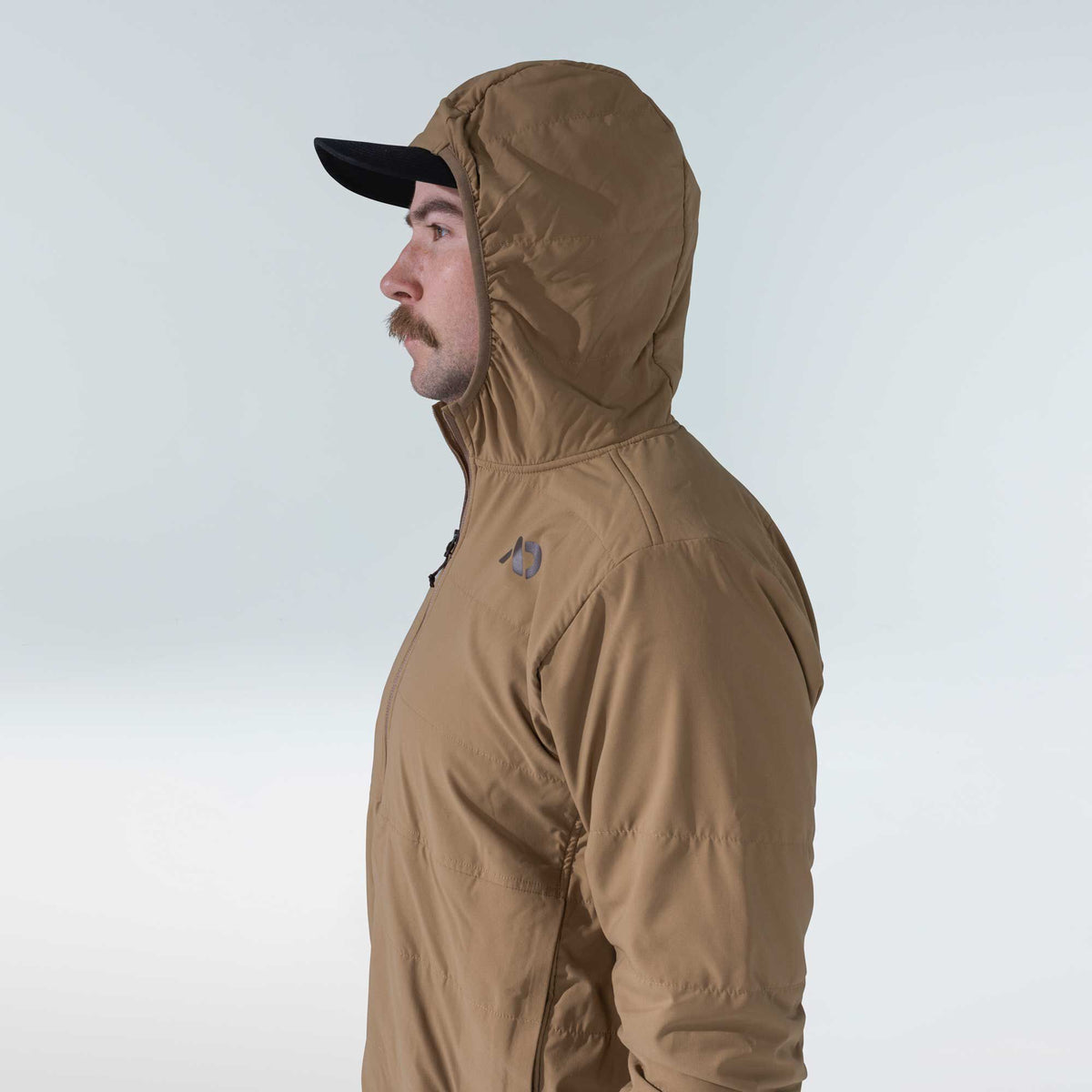 Tan insulated hooded jacket with a dark chest logo and front zipper.