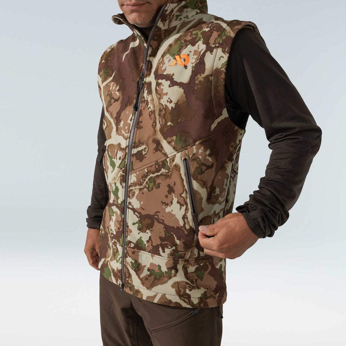 Men's camouflage vest with a full zipper, zippered pocket, and orange chest logo.