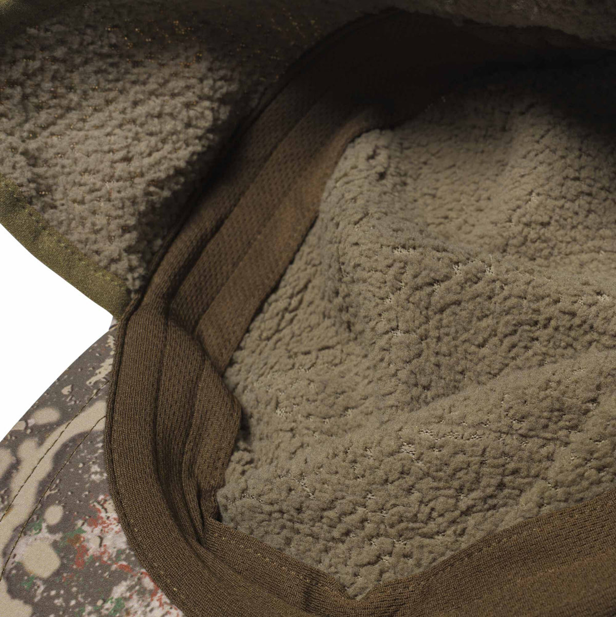Interior view of a hat featuring a warm brown fuzzy lining, a ribbed band, and a partial camouflage exterior.
