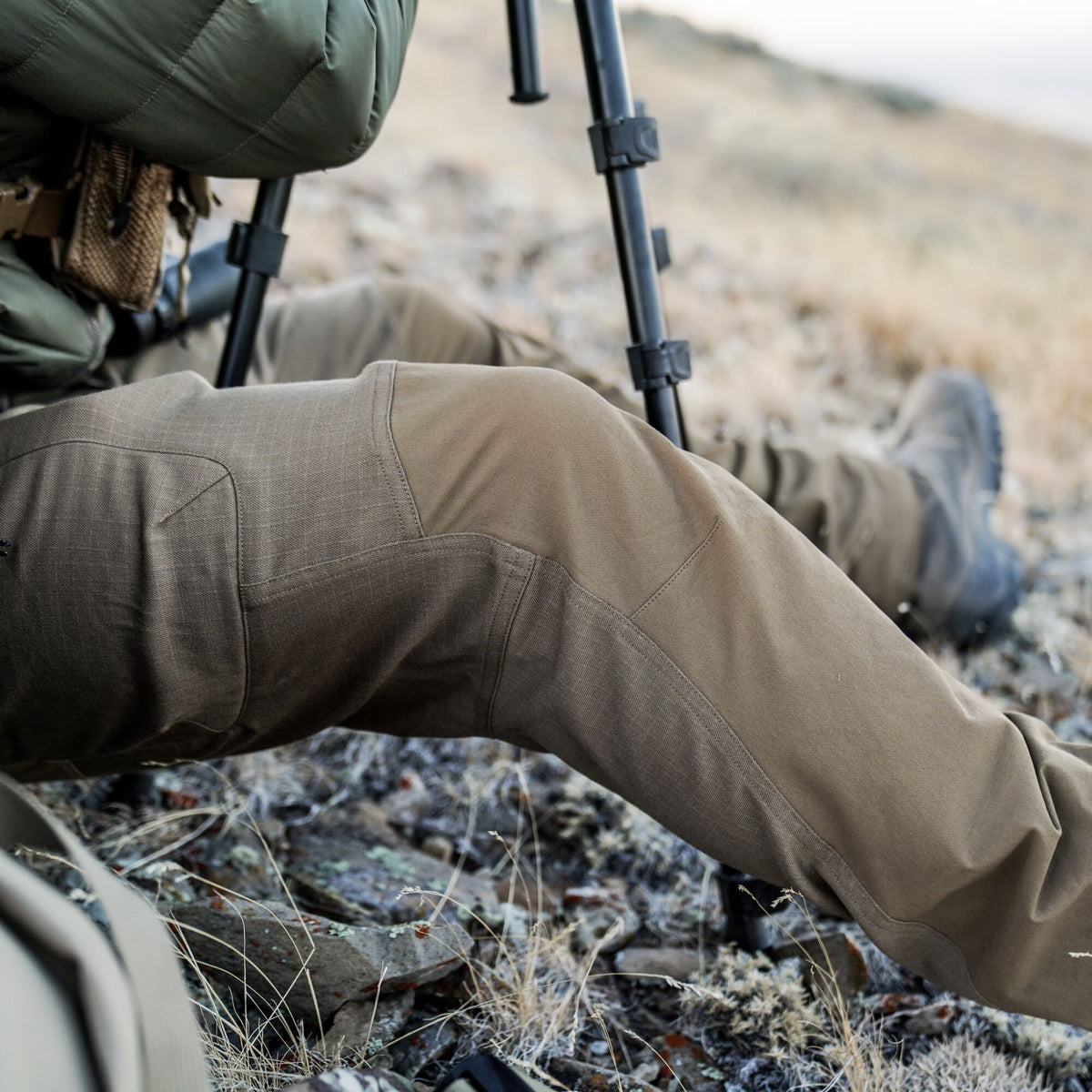 Brown hiking pants with reinforced, articulated knee panels.