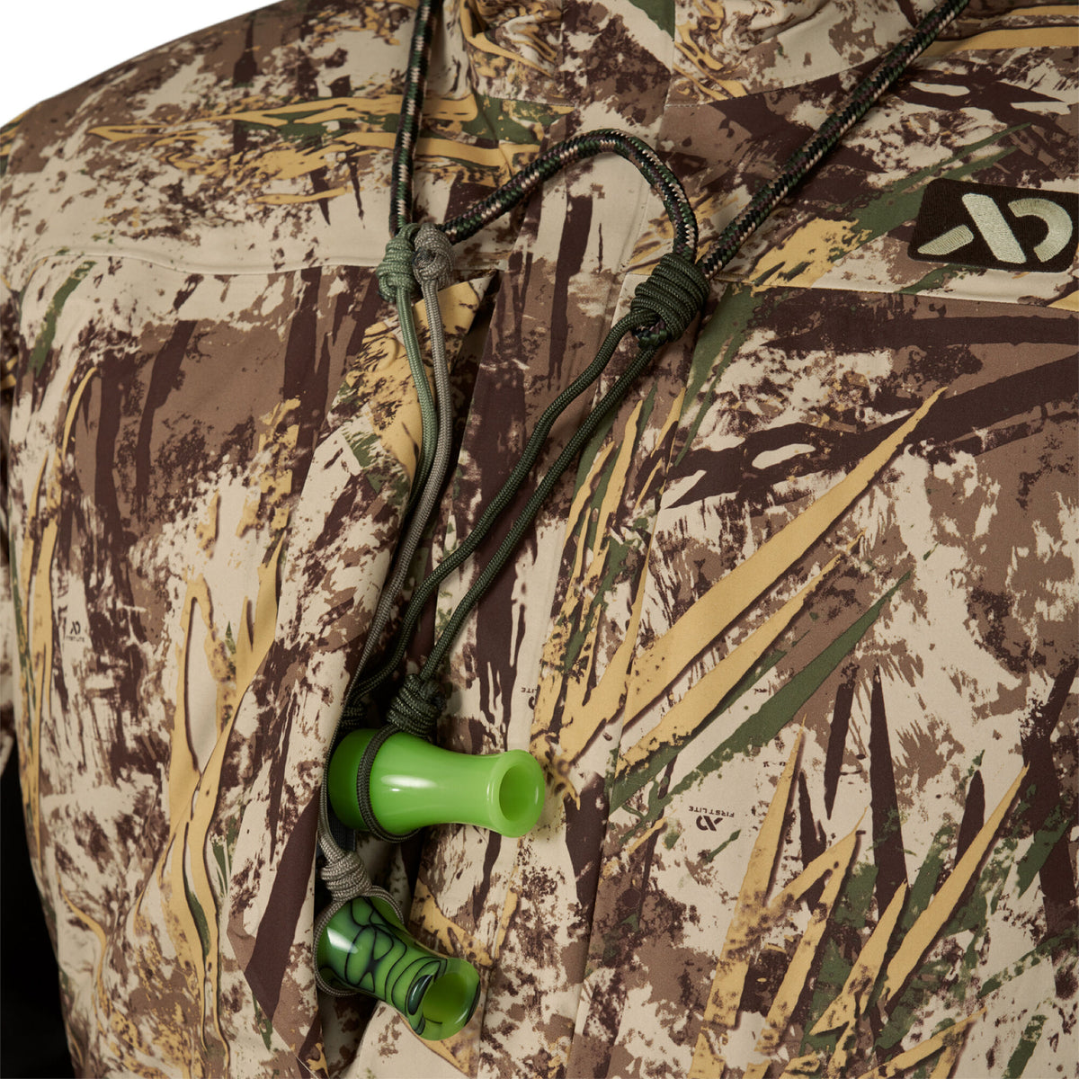 A camouflage hunting jacket displays two duck calls, one bright green and one dark green with a swirl pattern, hanging from a green braided lanyard.