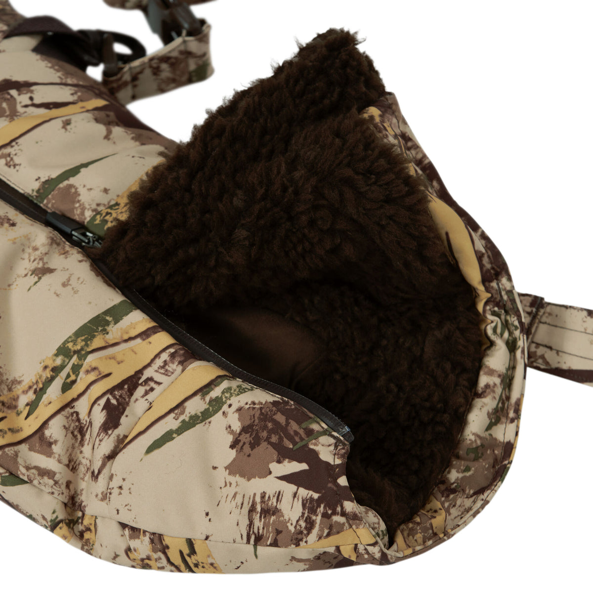 Desert camouflage hand muff with dark brown fur lining and a side zipper.