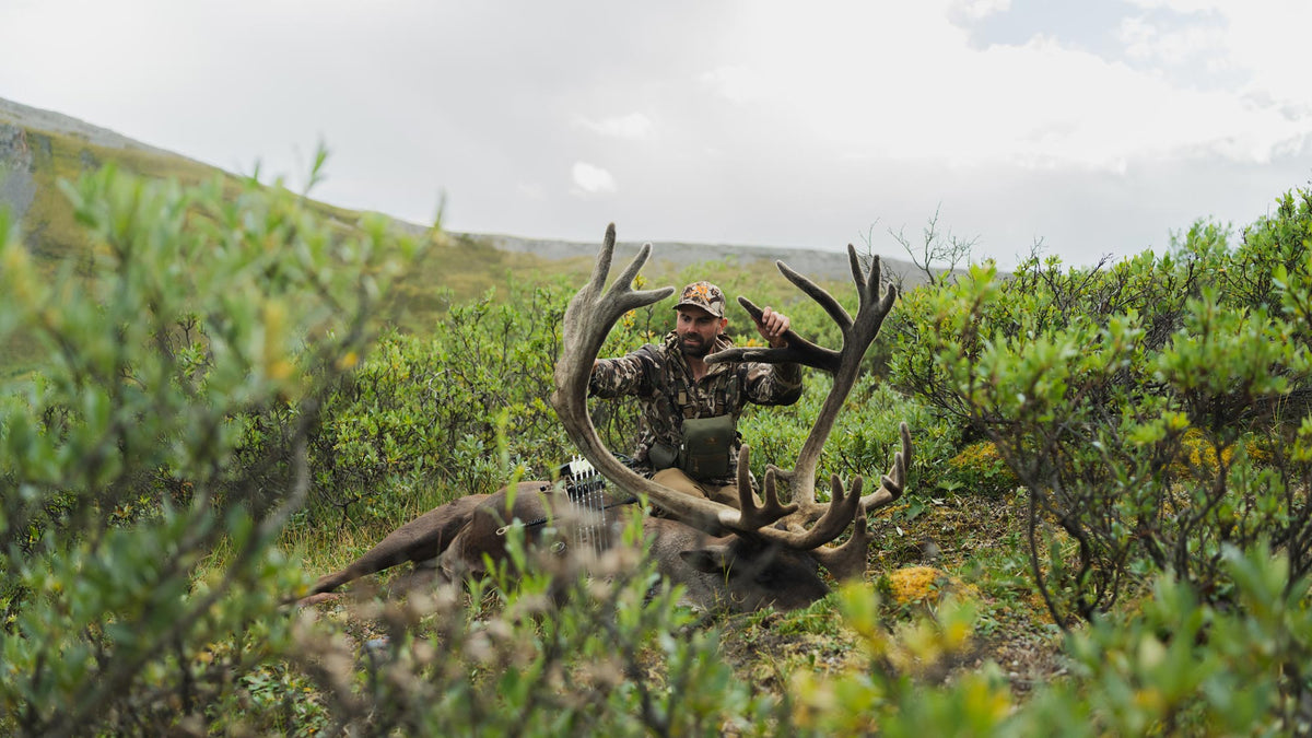 Remi Warren holding the antlers of a caribou. 